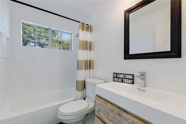 a bathroom with a toilet a sink and a bathtub