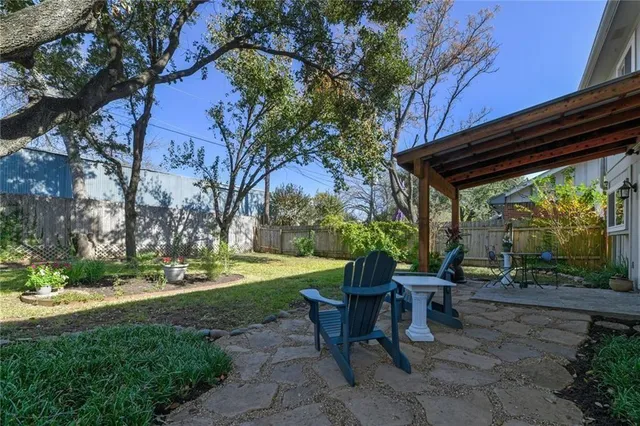 a view of a patio with table and chairs and potted plants
