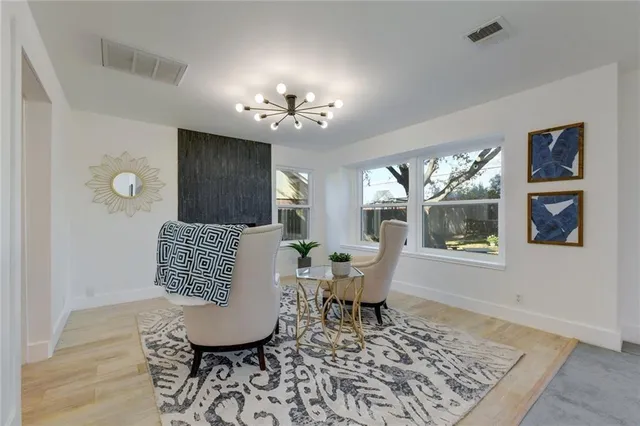 a living room with furniture rug and window
