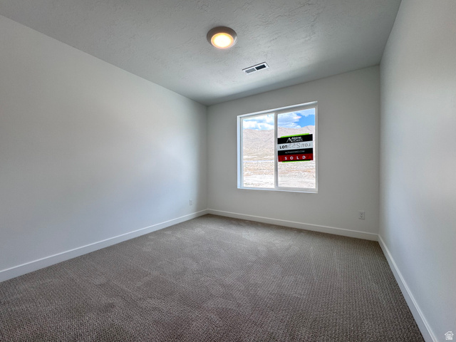 2633 Scarlet Road, Unit 259 Eagle Mountain, UT 84005 - Photo 27 of 30 Neutral-toned carpeting and white walls create a versatile interior