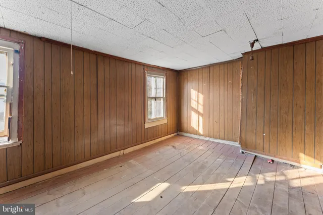 a living room with furniture and large windows