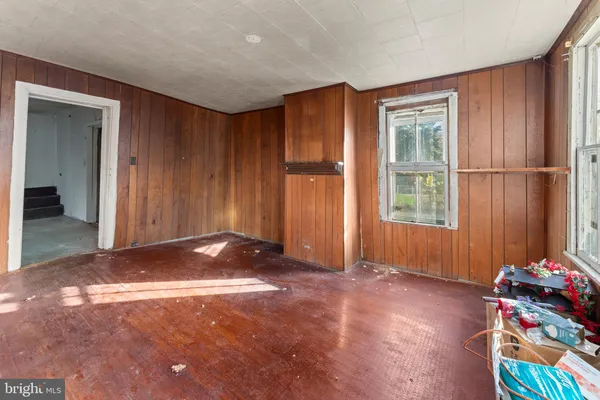 a room with table chairs and window