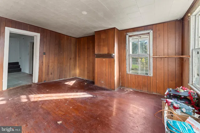 a room with table chairs and window