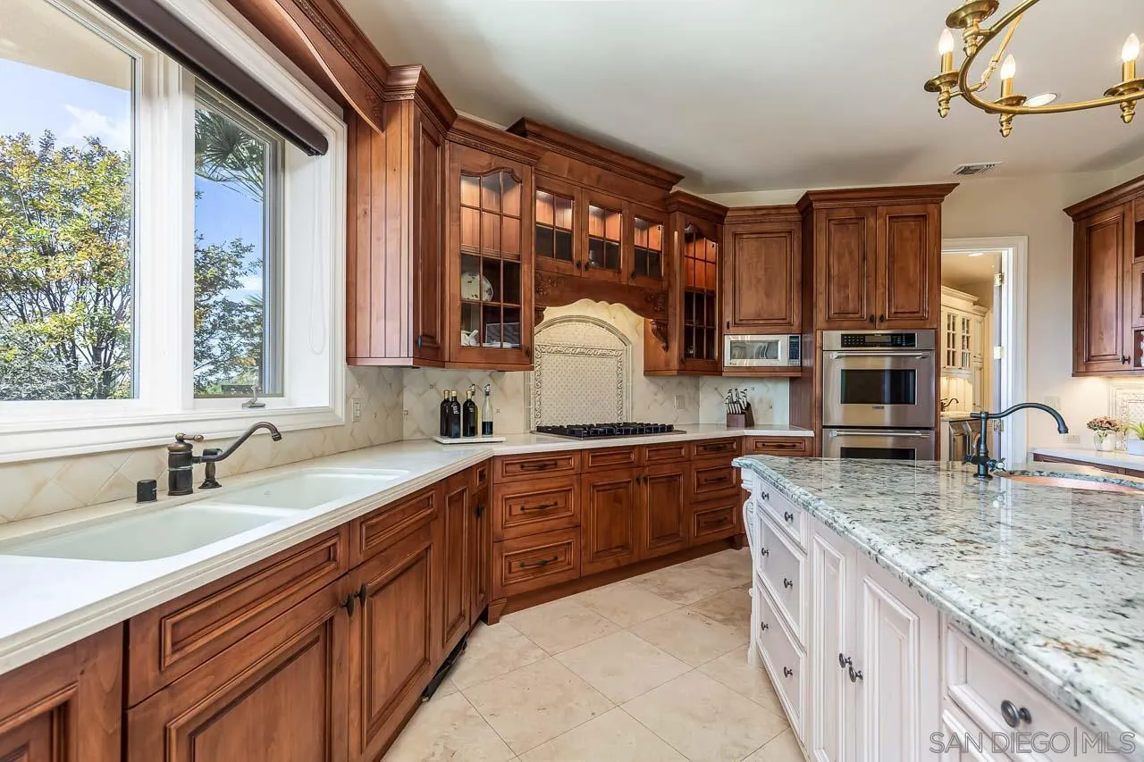 14440 Ridge Ranch Road Valley Center, CA 92082 - Photo 28 of 74 a kitchen with stainless steel appliances granite countertop a sink and a stove