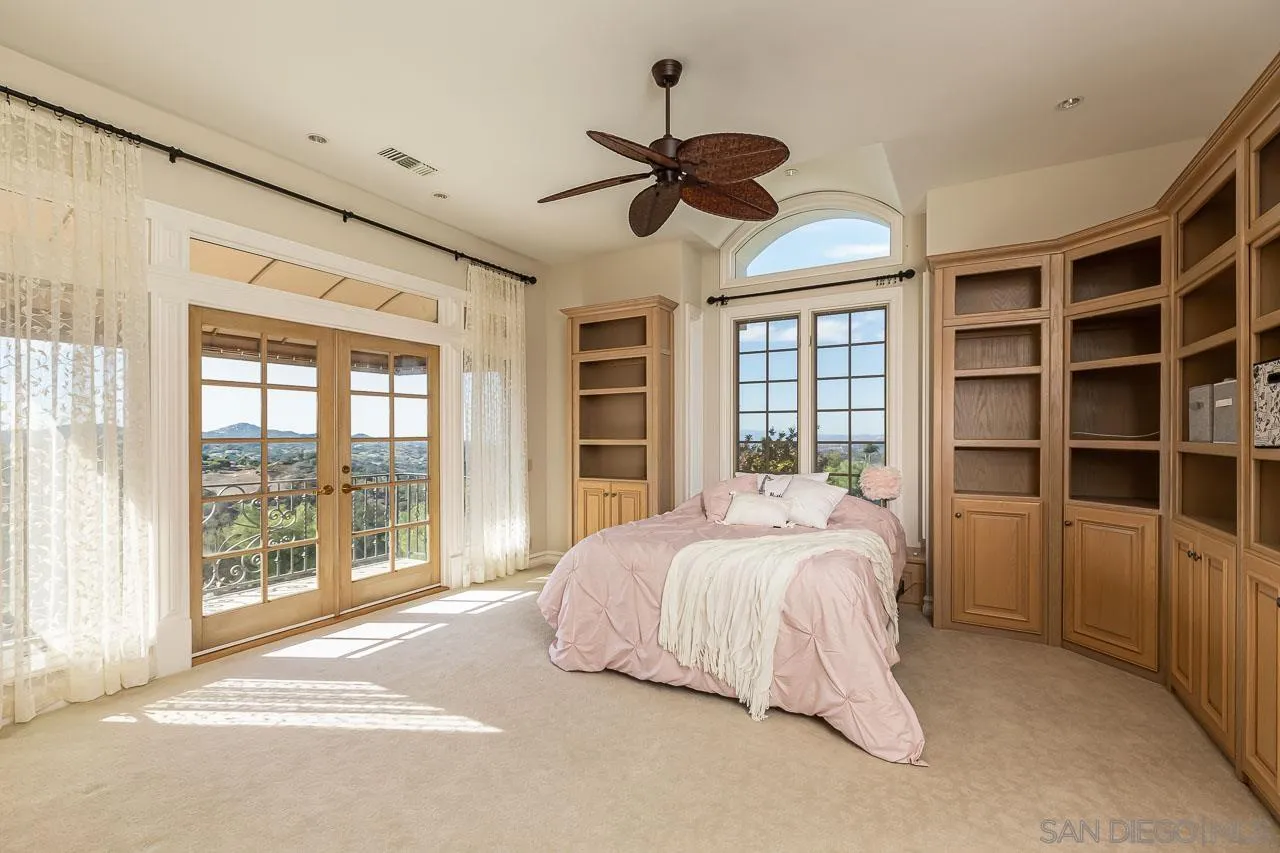 14440 Ridge Ranch Road Valley Center, CA 92082 - Photo 46 of 74 a spacious bedroom with a large bed and a large window