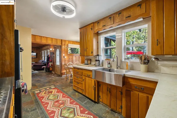 a large kitchen with kitchen island granite countertop a large window