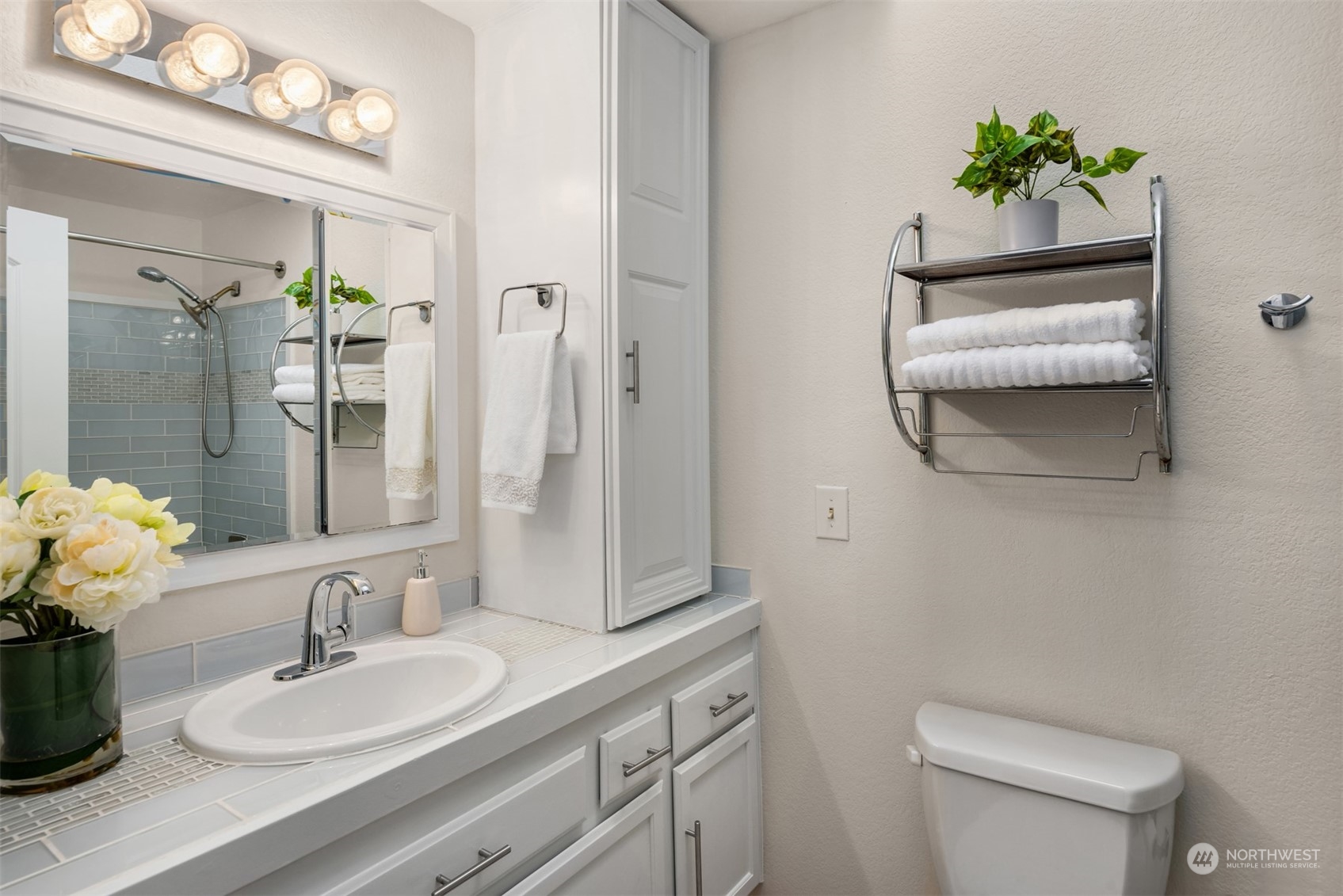 22327 19th Avenue Southeast Bothell, WA 98021 - Photo 11 of 22 a bathroom with a sink a toilet and mirror