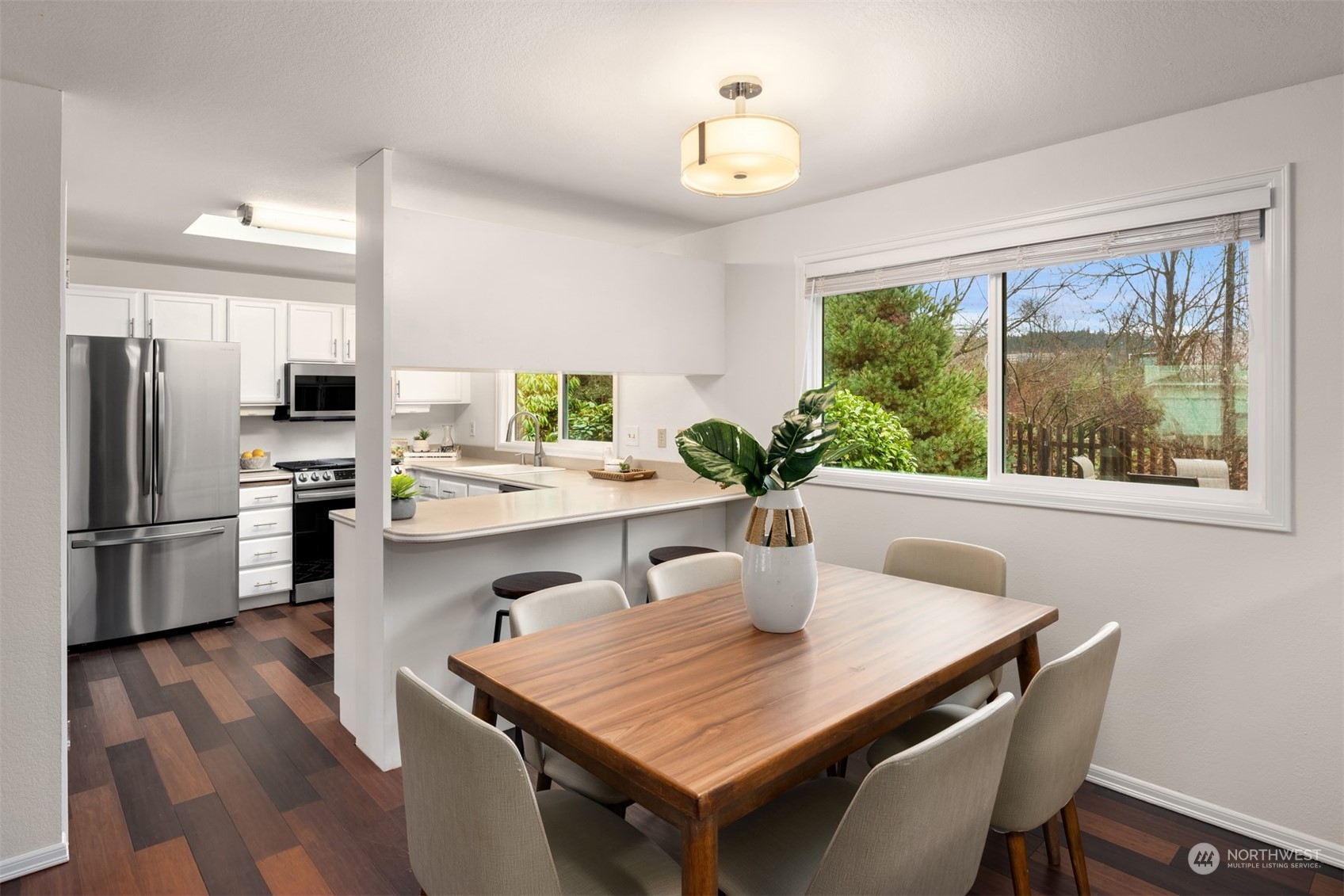 22327 19th Avenue Southeast Bothell, WA 98021 - Photo 9 of 22 a kitchen with a table chairs refrigerator and cabinets