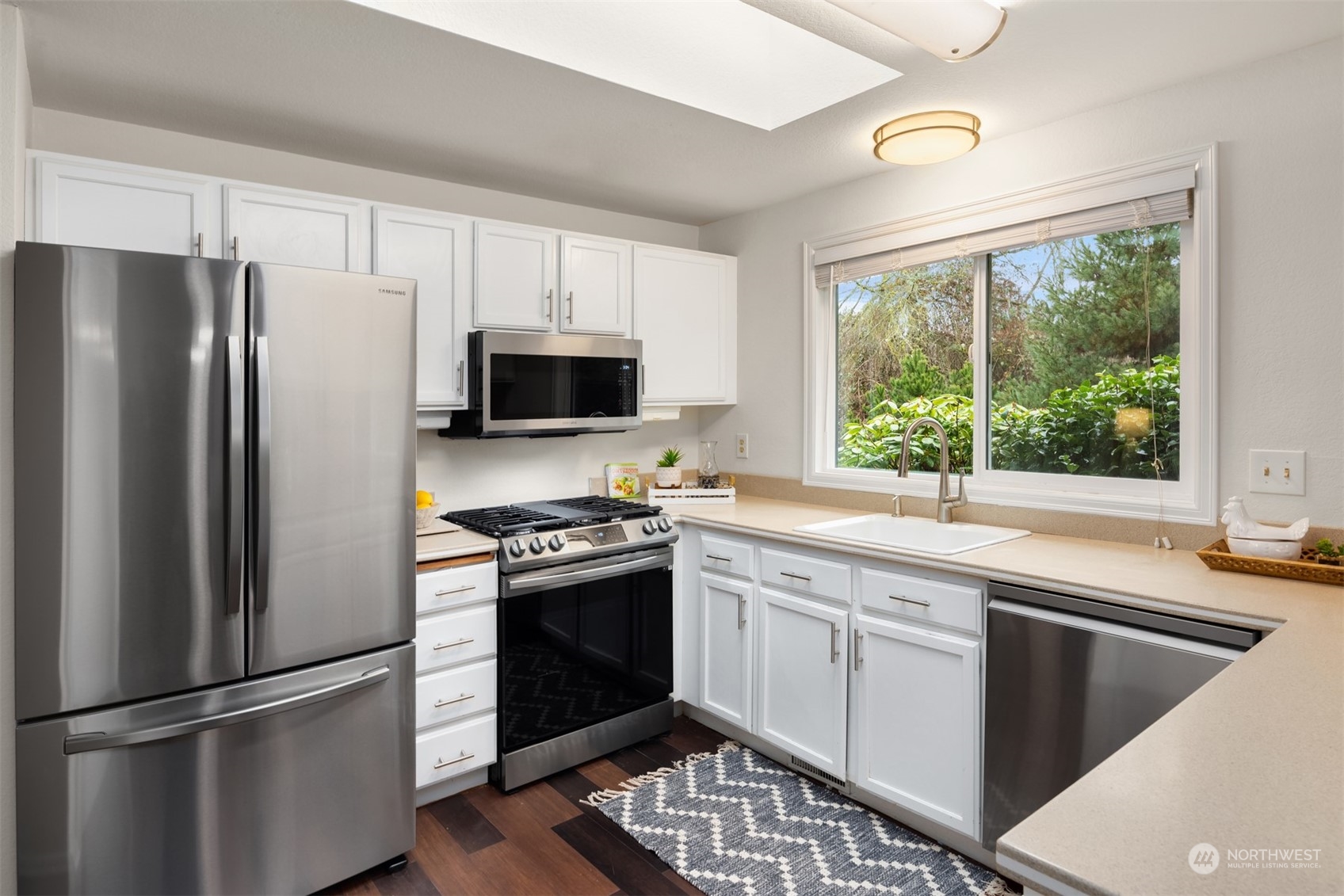 22327 19th Avenue Southeast Bothell, WA 98021 - Photo 10 of 22 a kitchen with a refrigerator stove and sink
