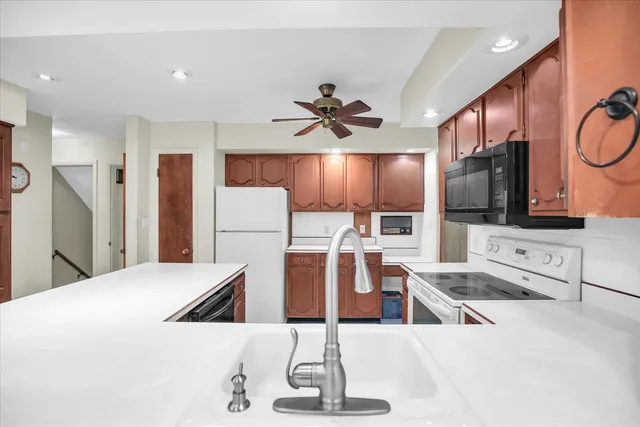 a kitchen with a stove a refrigerator and a sink