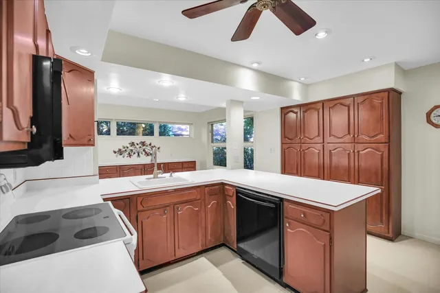 a view of a kitchen with microwave and windows