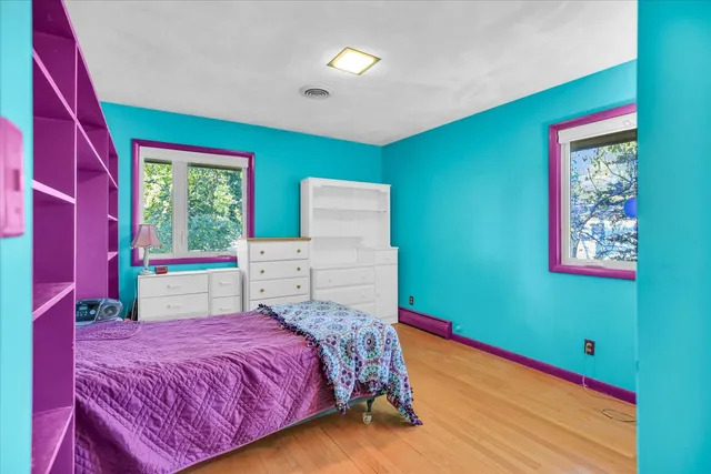 a bedroom with a bed and a small yard