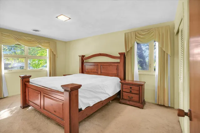 a bedroom with a bed and a table