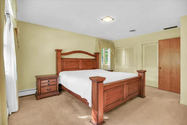 a bedroom with a bed and a mirror