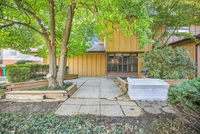 a view of a patio with table and chairs and potted plants
