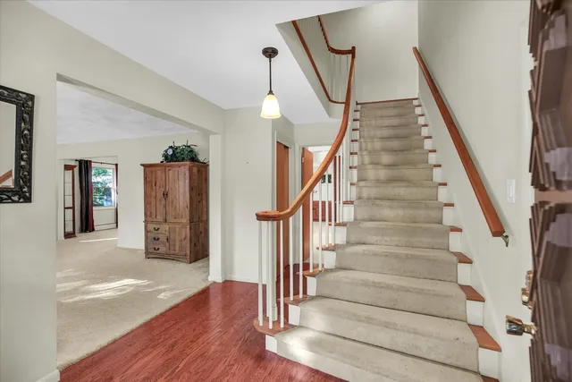 a view of an entryway with wooden floor and windows