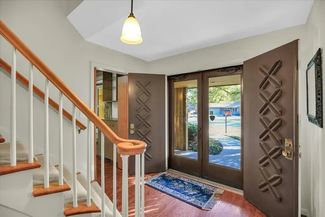 a living room with furniture and large windows