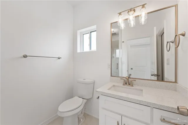 a bathroom with a toilet sink shower and mirror