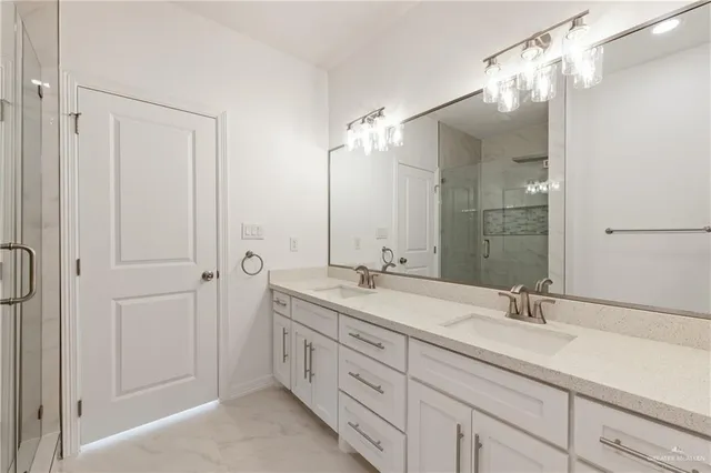 a bathroom with a double vanity sink and mirror