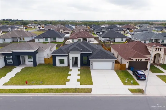 an aerial view of multiple houses with yard