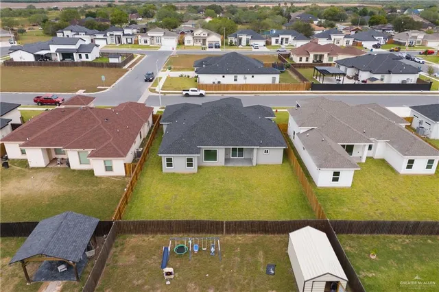 an aerial view of residential houses with outdoor space