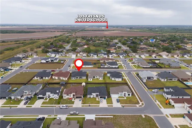 an aerial view of residential houses with outdoor space