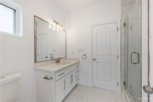 a bathroom with a granite countertop sink a mirror and a shower