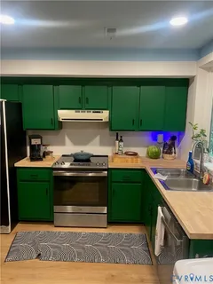 a kitchen with stainless steel appliances granite countertop a sink and a stove