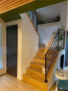 a view of entryway and hall with wooden floor