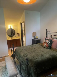 a bedroom with a bed a desk and chair
