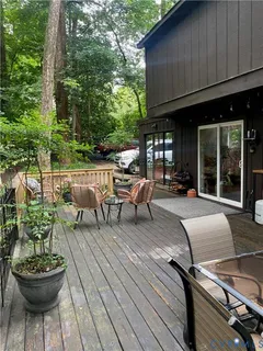 a living room with patio furniture and a potted plant