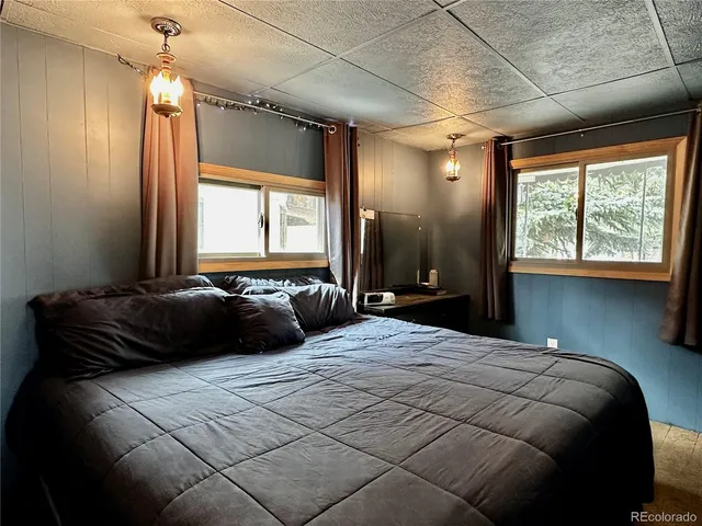 a bedroom with a bed and a chandelier