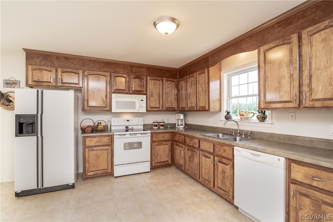17127 Loving Union Road Disputanta, VA 23842 - Photo 11 of 26 a kitchen with stainless steel appliances granite countertop a stove a sink dishwasher a refrigerator and cabinets with wooden floor