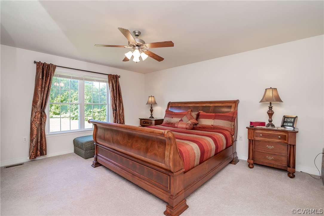 17127 Loving Union Road Disputanta, VA 23842 - Photo 15 of 26 a bed room with a bed and a chandelier
