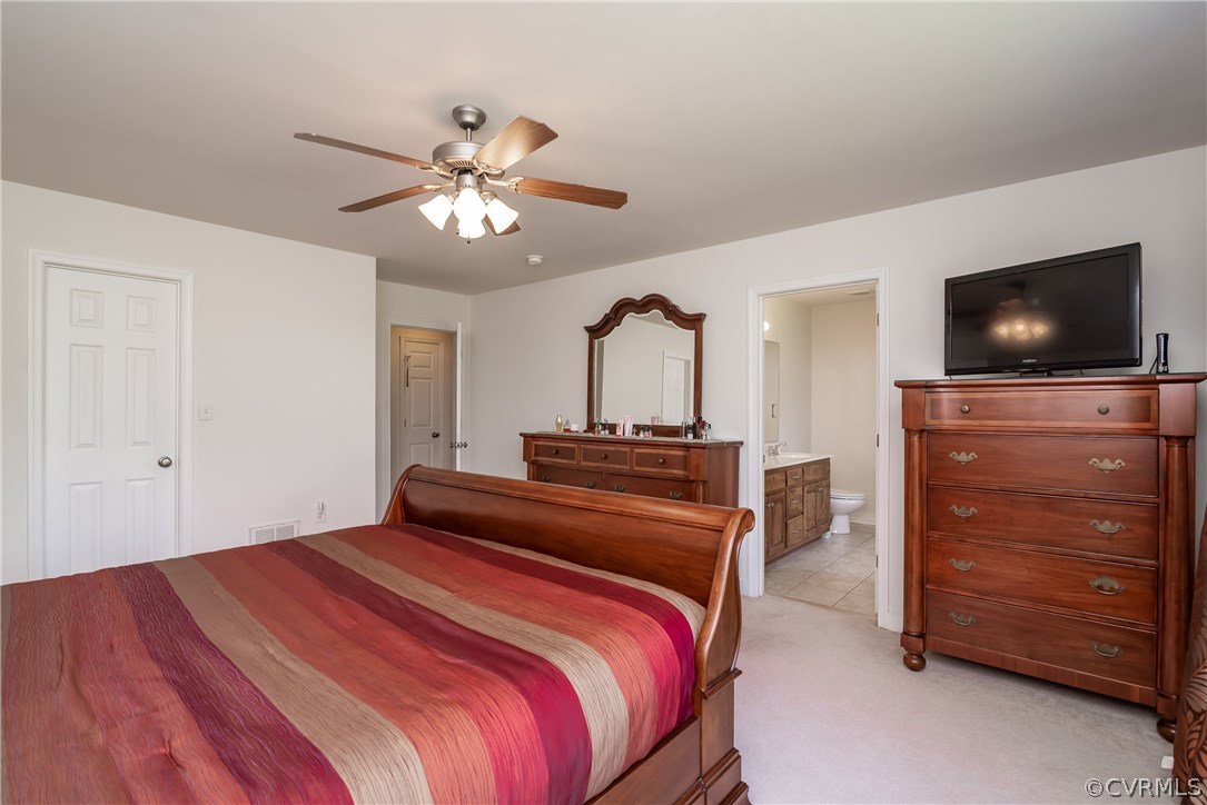17127 Loving Union Road Disputanta, VA 23842 - Photo 17 of 26 a bedroom with a bed and a flat tv screen on dresser