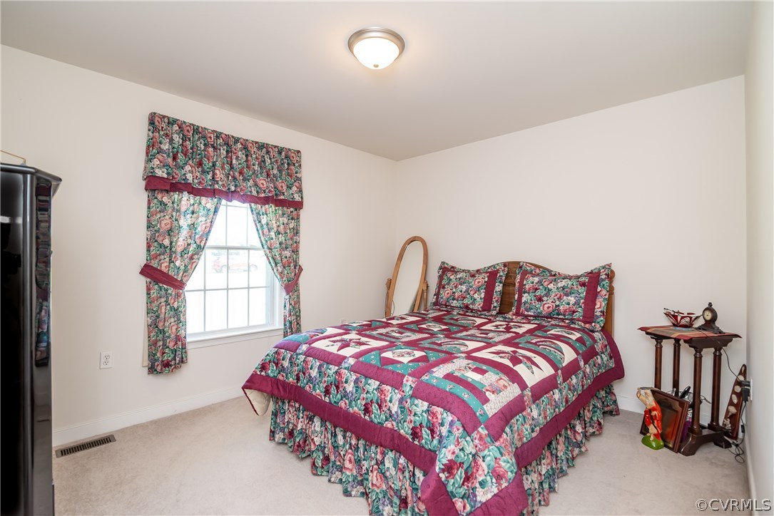 17127 Loving Union Road Disputanta, VA 23842 - Photo 20 of 26 a bedroom with a bed and a window