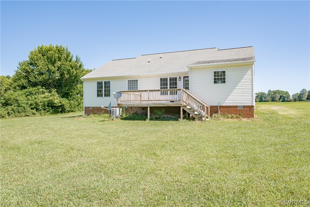 17127 Loving Union Road Disputanta, VA 23842 - Photo 24 of 26 a view of a house with a backyard and a patio