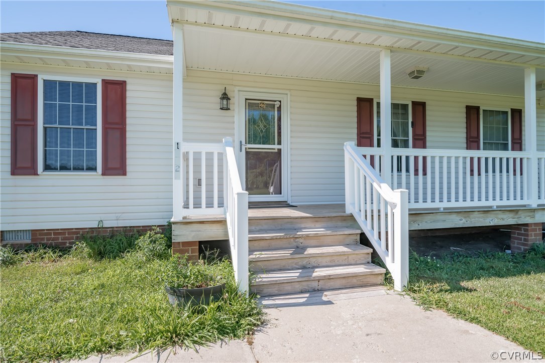 17127 Loving Union Road Disputanta, VA 23842 - Photo 3 of 26 a view of a house with backyard and porch