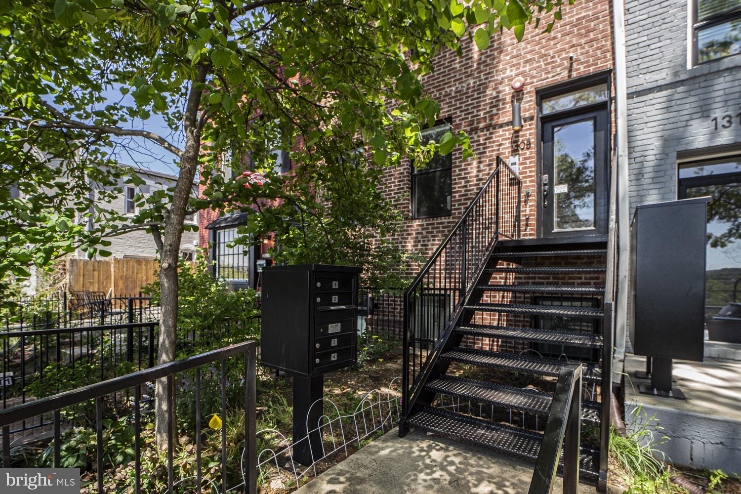 1308 L Street Southeast, Unit 2 Washington, DC 20003 - Photo 2 of 12 Charming entrance with lush greenery.