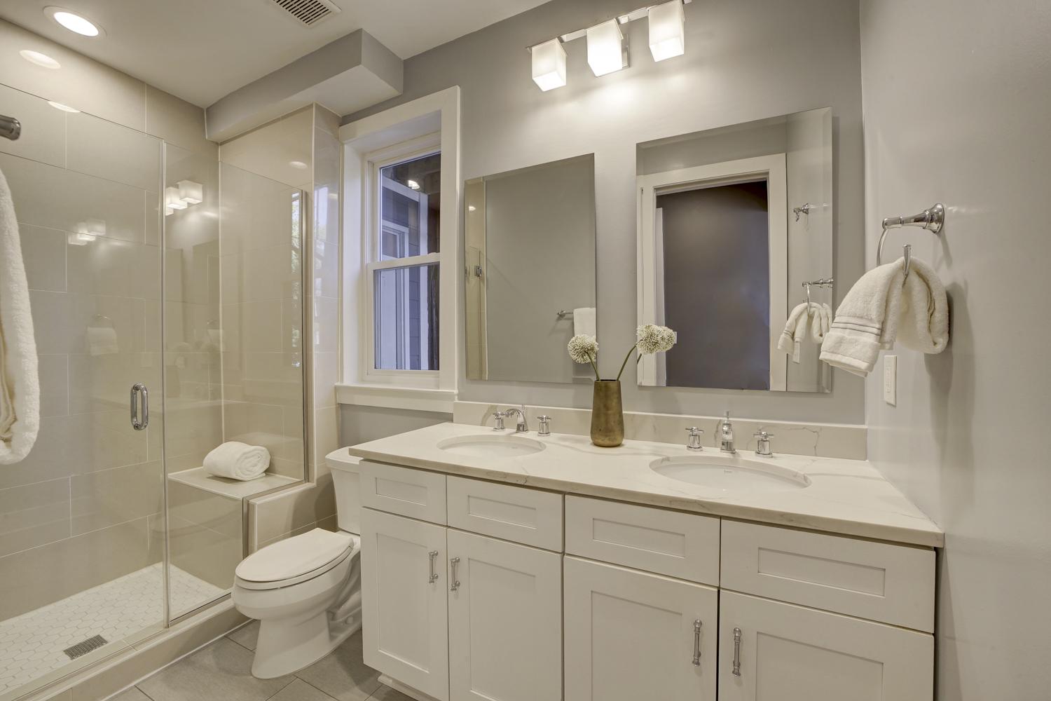 1308 L Street Southeast, Unit 2 Washington, DC 20003 - Photo 8 of 12 Spa-like primary bathroom with dual sink vanity.