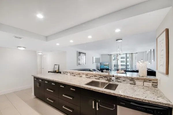 a large kitchen with stainless steel appliances and a stove