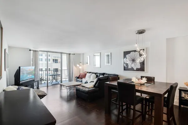 a living room with furniture wooden floor and a table