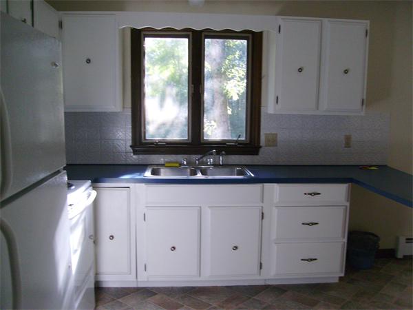 288 Mill Road Fairhaven, MA 02719 - Photo 11 of 22 a view of cabinets a window and a wooden floor