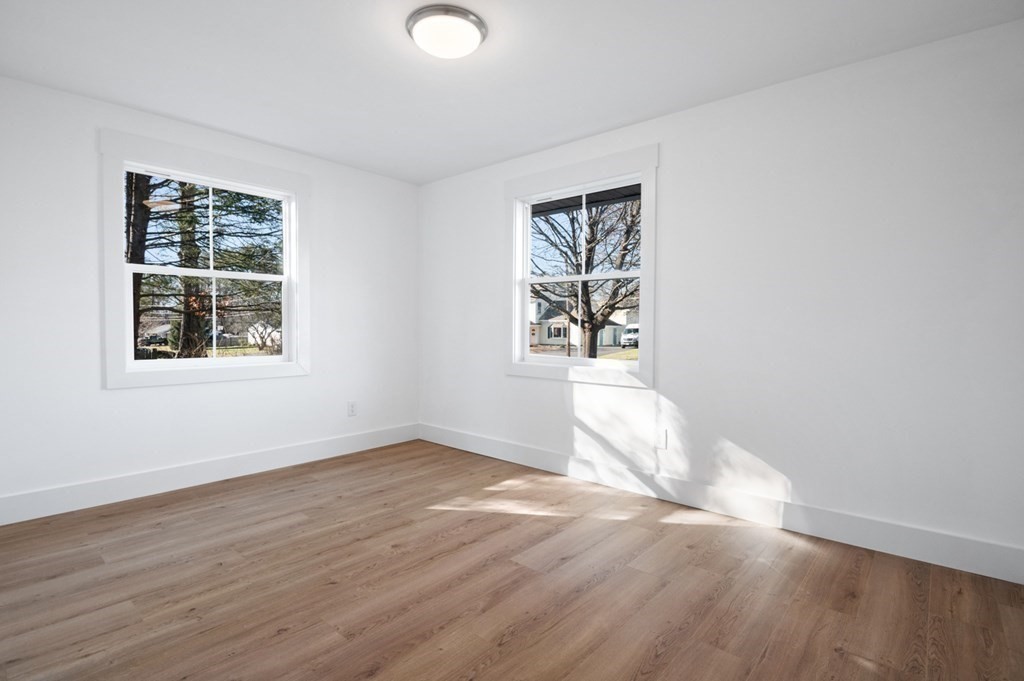 27 Trinity Street Danvers, MA 01923 - Photo 14 of 27 an empty room with wooden floor and windows