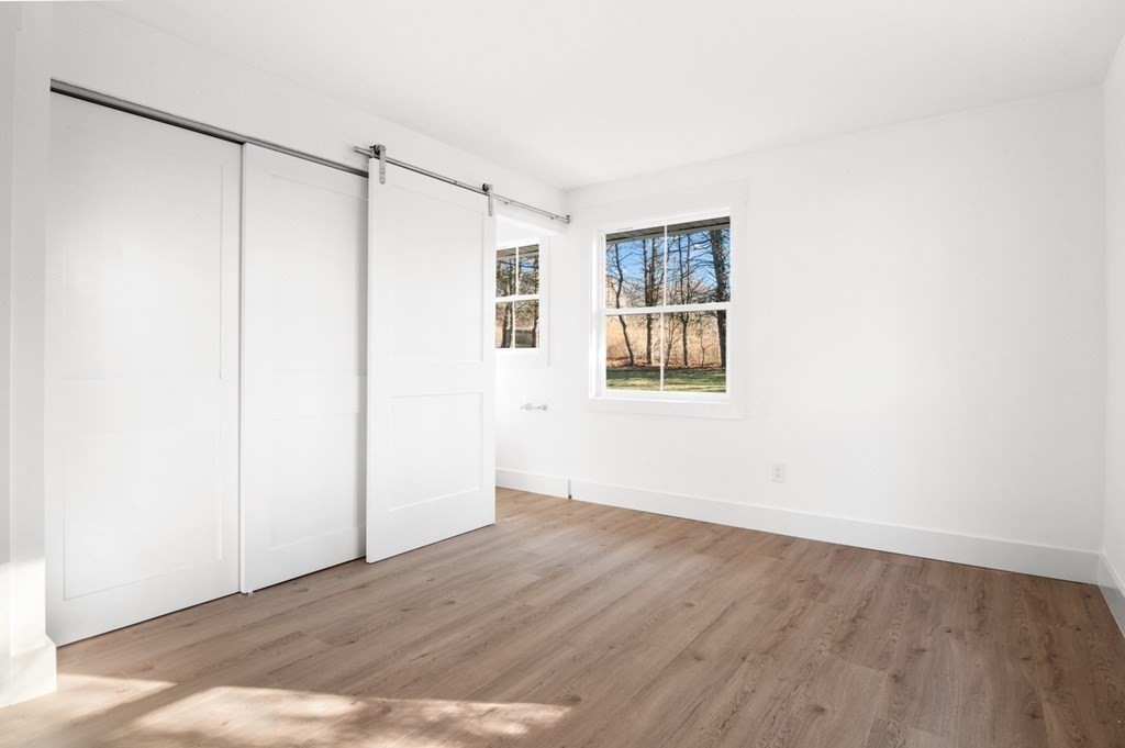 27 Trinity Street Danvers, MA 01923 - Photo 18 of 27 a view of an empty room with wooden floor and a window