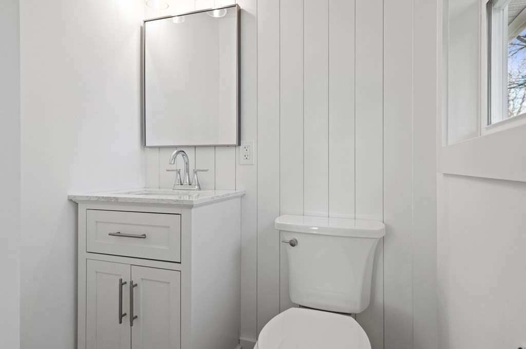 27 Trinity Street Danvers, MA 01923 - Photo 19 of 27 a bathroom with a toilet sink and mirror