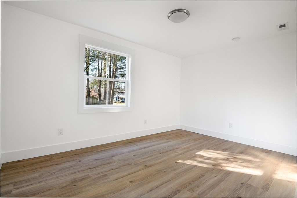 27 Trinity Street Danvers, MA 01923 - Photo 20 of 27 an empty room with wooden floor and windows