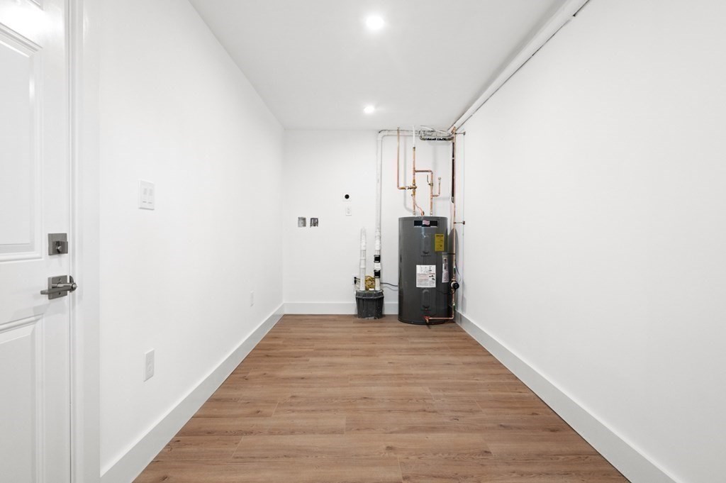 27 Trinity Street Danvers, MA 01923 - Photo 21 of 27 a view of a hallway with wooden floor