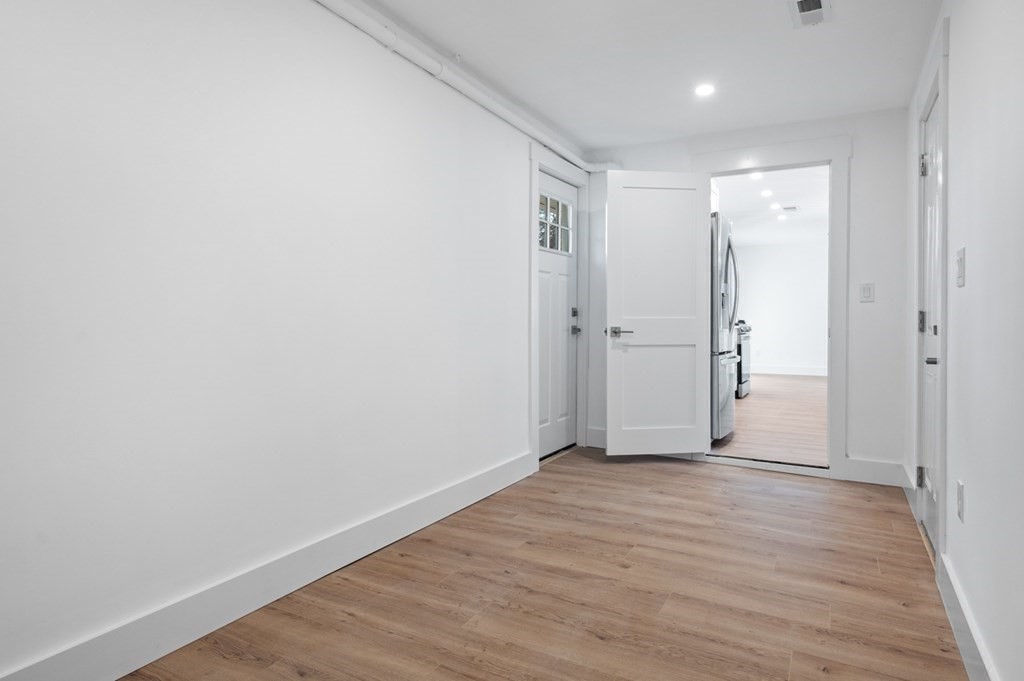 27 Trinity Street Danvers, MA 01923 - Photo 22 of 27 a view of an empty room with wooden floor