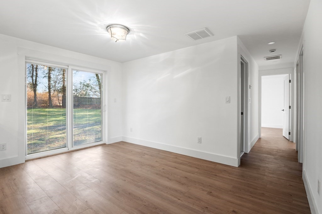 27 Trinity Street Danvers, MA 01923 - Photo 25 of 27 wooden floor in an empty room with a window